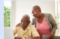 Elderly couple reading about social security online