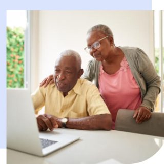 Elderly couple reading about social security online