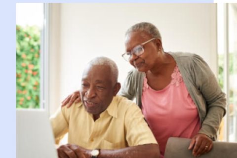 Elderly couple reading about social security online