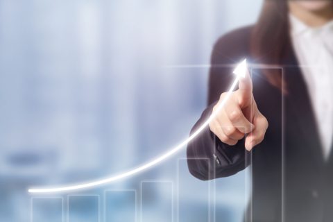 Woman pointing at a graph trending upwards