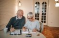 Senior couple reviewing their finances at home