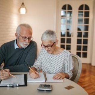 Senior couple reviewing their finances at home