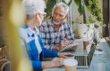 Mature adults reviewing their retirement finances on a laptop