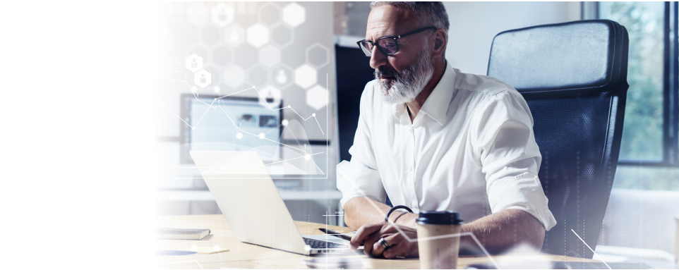 Photograph of a man using his laptop with an overlay of graphs, charts, and financial data